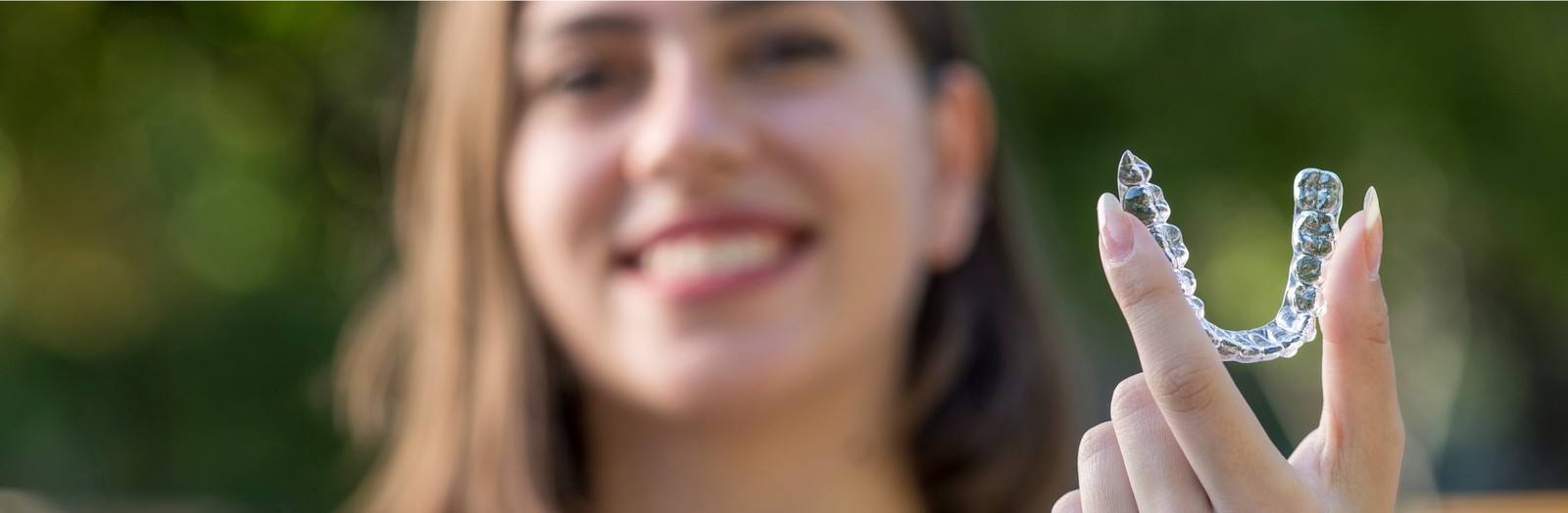 a girl holding invislaign