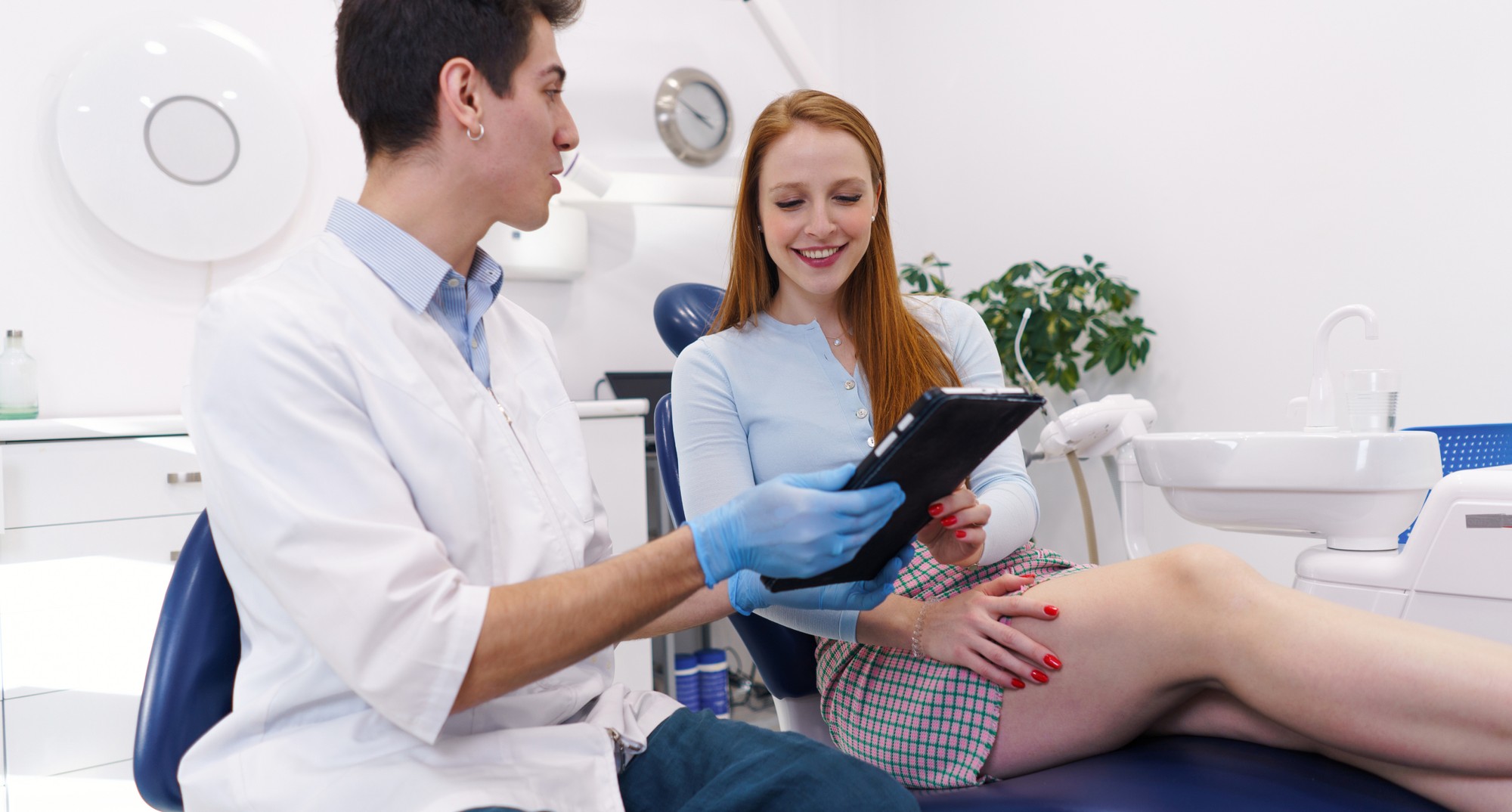 doctor talking to patient sitting in a dental chair